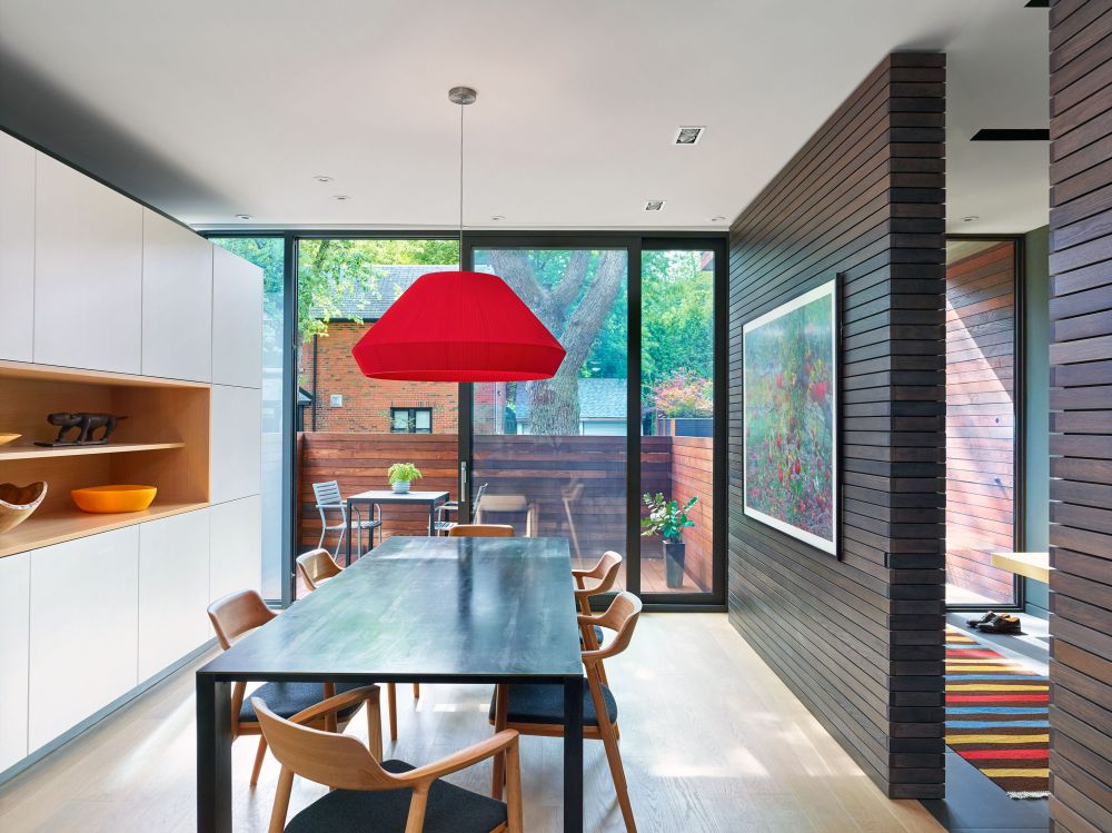 A sliding glass door connects the dining area to the front patio which serves as an extension for the indoor spaces