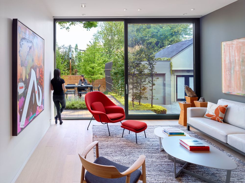 The rear of the house opens up towards the backyard, welcoming the outdoors in