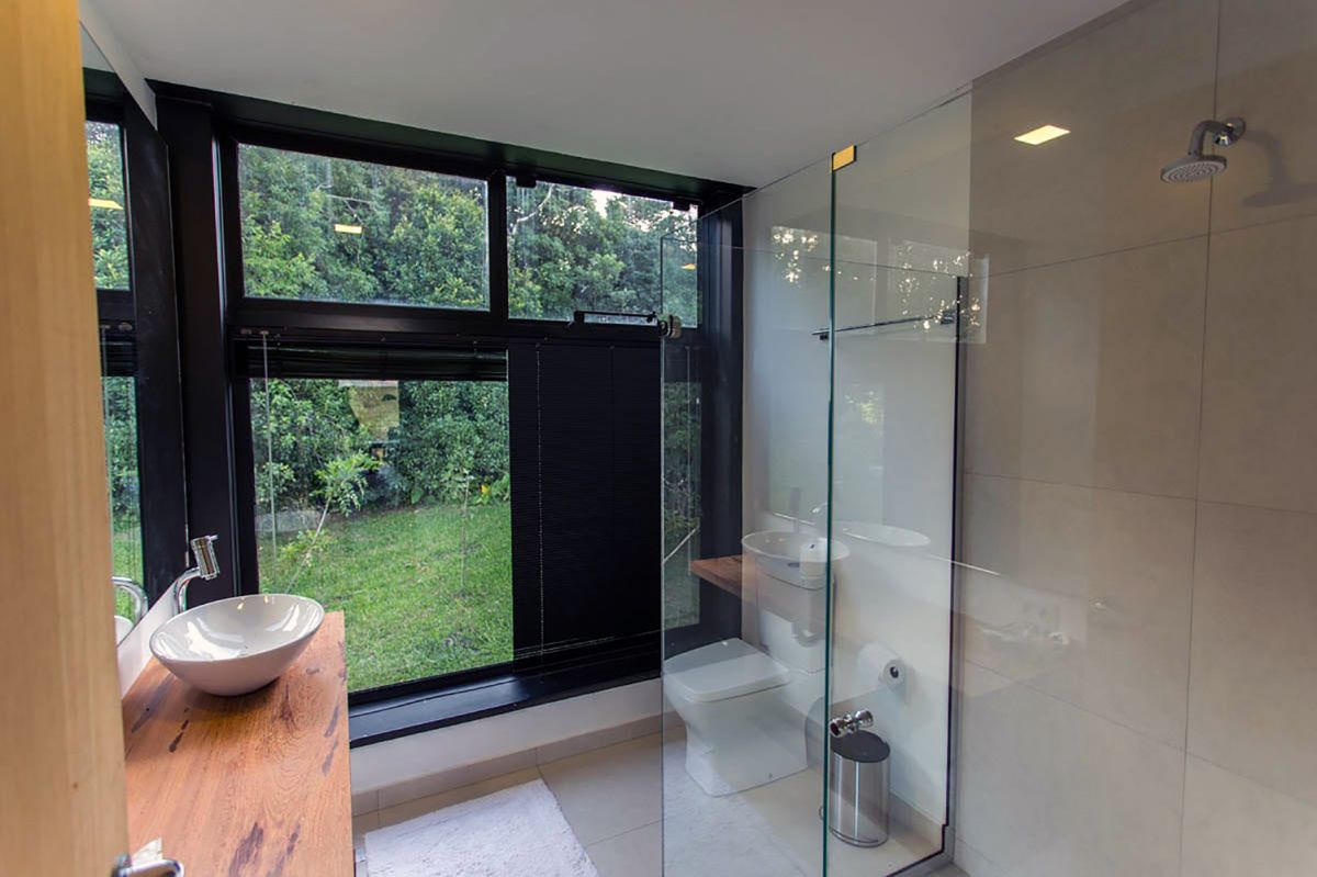 The bathroom has its own share of windows that bring in the beauty of the outdoors