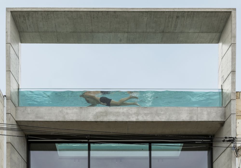 The swimming pool has a glass bottom and glass sides which make it almost completely transparent
