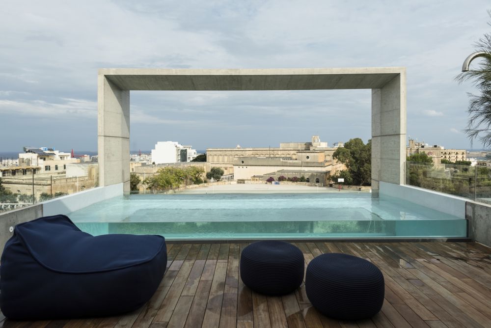 On the rooftop there is a transparent swimming pool complemented by an open deck