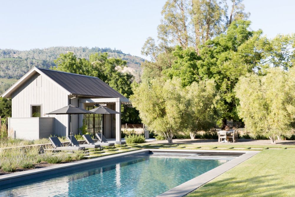 The poolhouse is a smaller version of the main residence, featuring an almost identical design