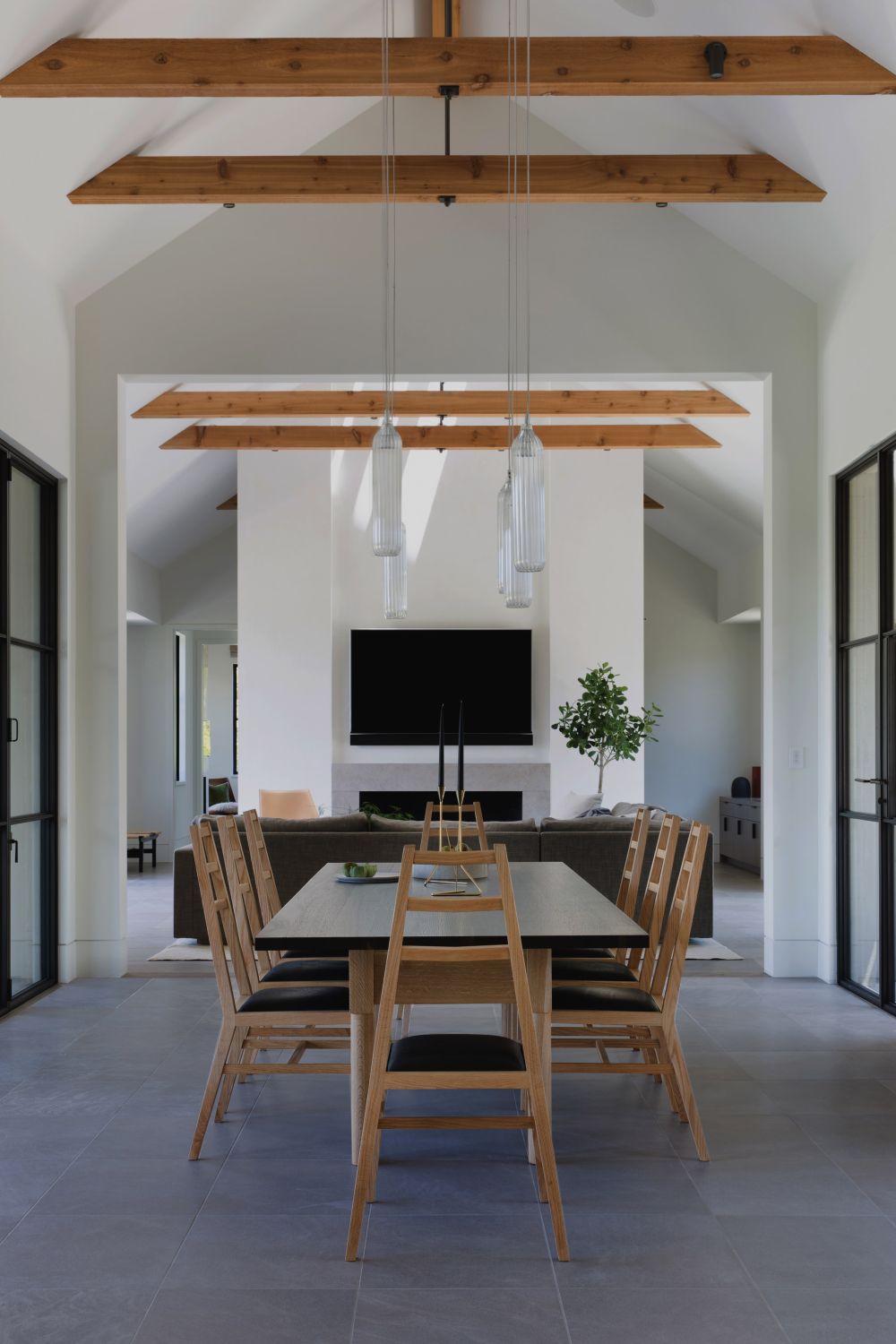 The formal dining area consists of a dark-stained table with classic wooden chairs around it