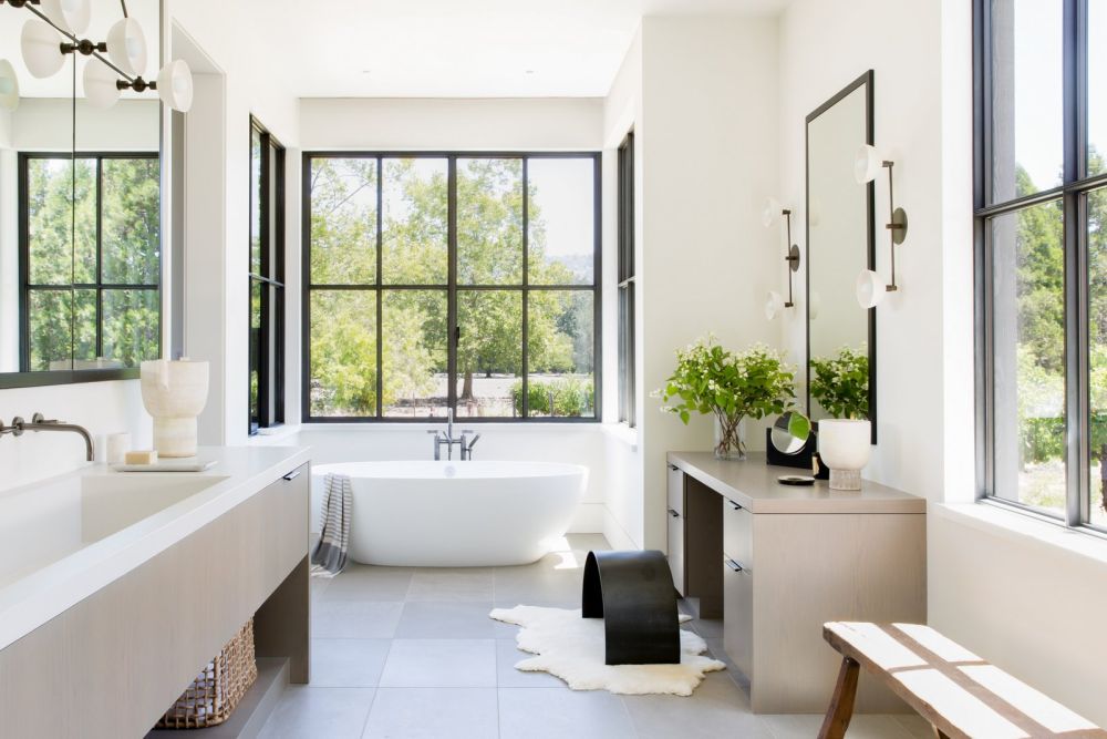 Large mirrors reflect the beautiful views coming through the windows, making the bathroom seem fresh and spacious