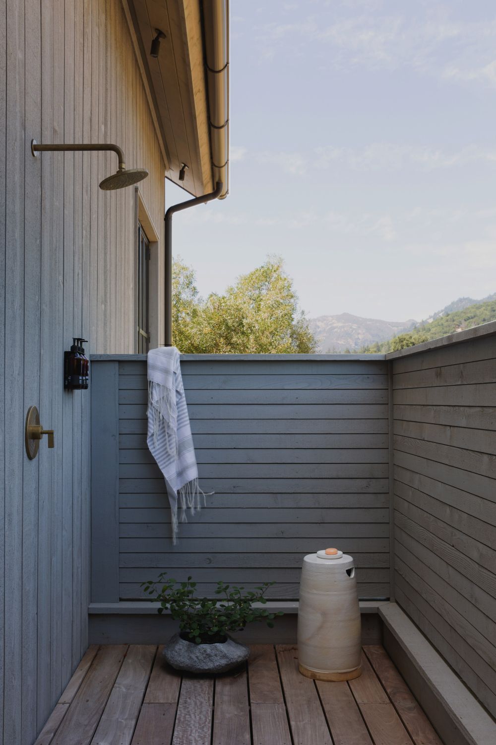 An outdoor shower complements the poolhouse, making the most of this wonderful location