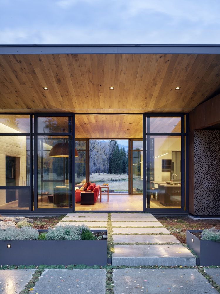 The deep overhangs offer protection but also ensure a seamless connection between the indoor and outdoor spaces