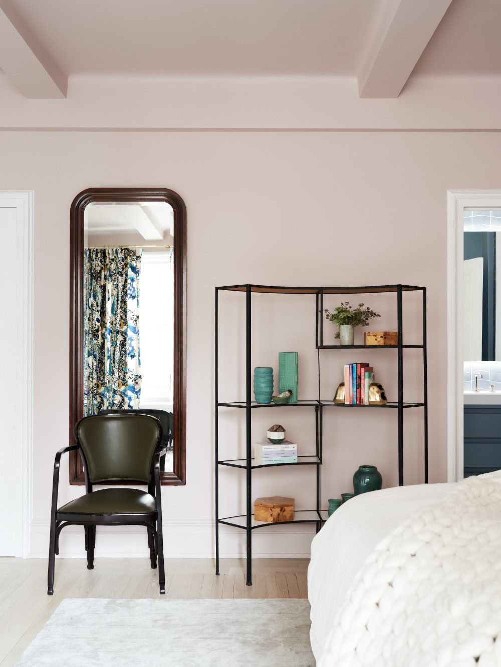 The walls and the ceiling of the bedroom have been painted in a pastel shade of pink which looks very trendy