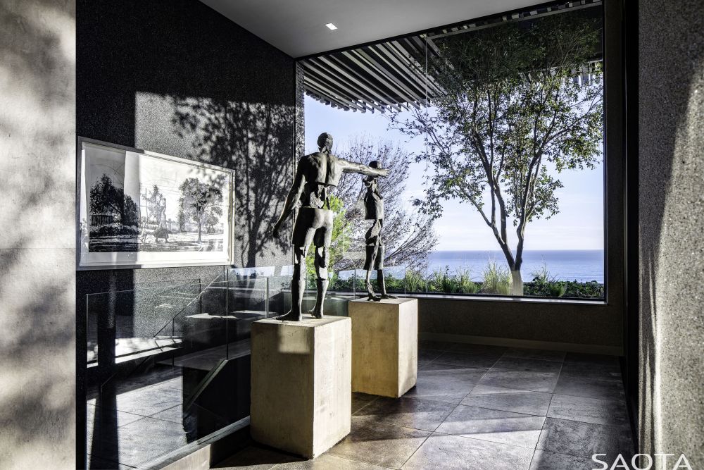 Large windows and openings seamlessly connect the indoor and outdoor and frame these extraordinary views