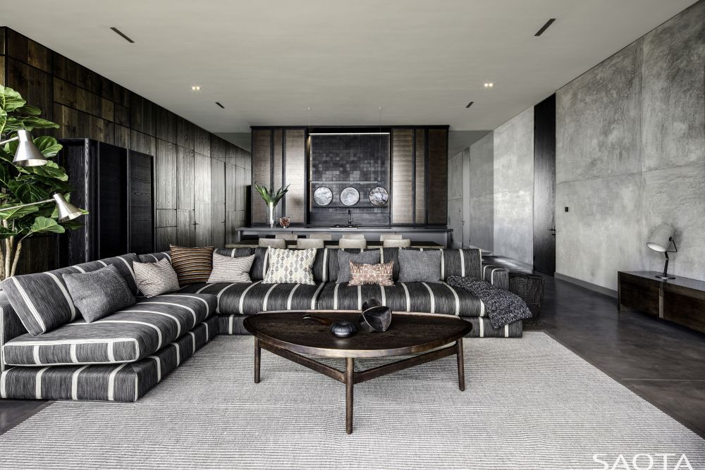 This living room has a large L-shaped sectional which delineates a very inviting sitting area
