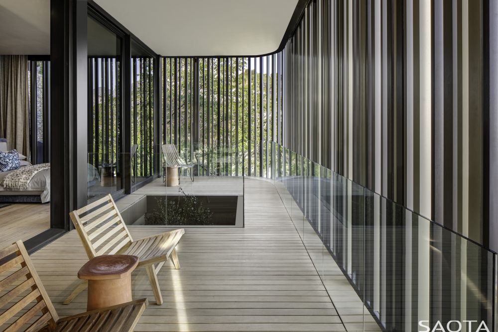 The master bedroom opens onto an enclosed space with a patio-like vibe
