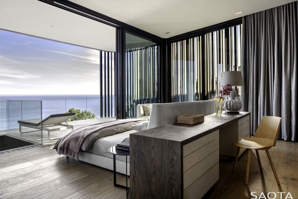The bedroom terrace is a seamless extension of the interior space and has transparent glass railings