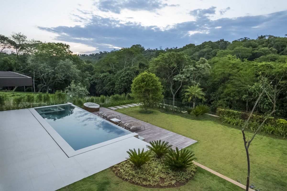 There's a wooden deck one level below the pool, overlooking the garden and preserving an unobstructed view