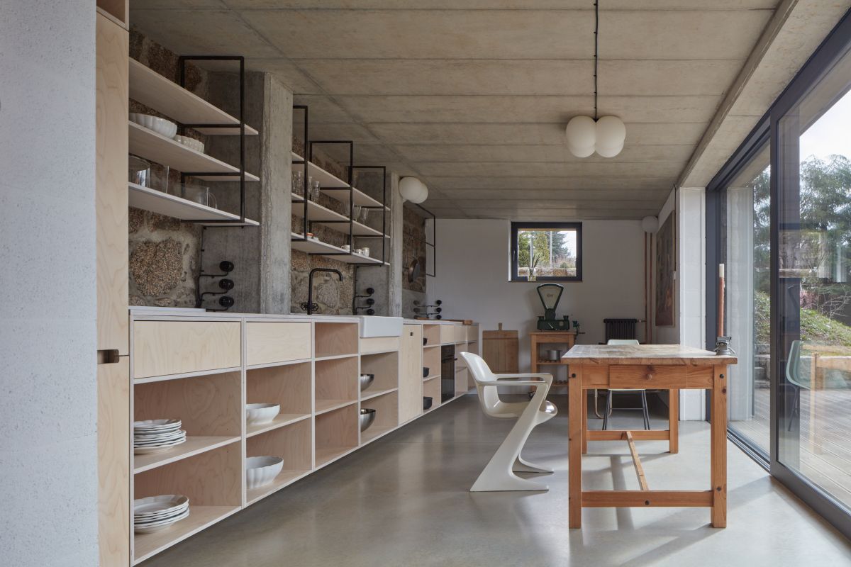 The stone-clad volume houses some of the social areas, featuring large glazed surfaces that let the outdoors in
