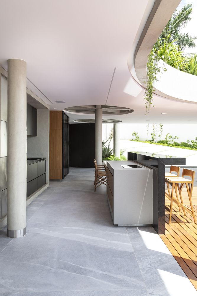There's a transitional area between the kitchen and the pool where a barbecue grill area is set up