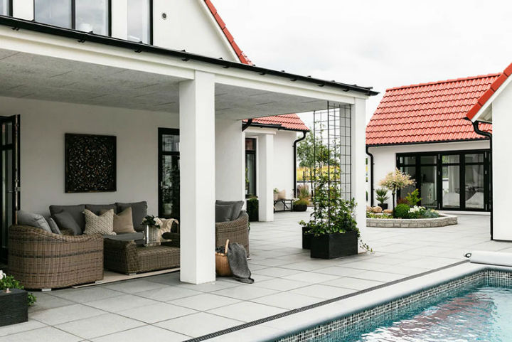 home with high ceiling and pool