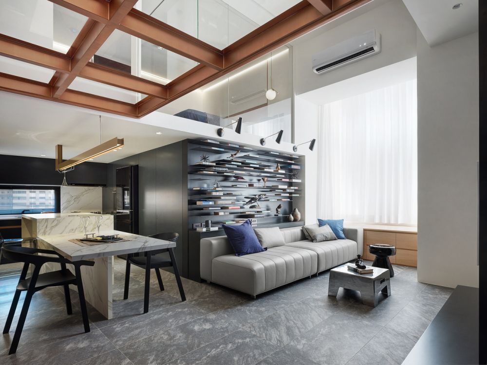 The living area features a double-height ceiling which gives this entire floor a very airy look