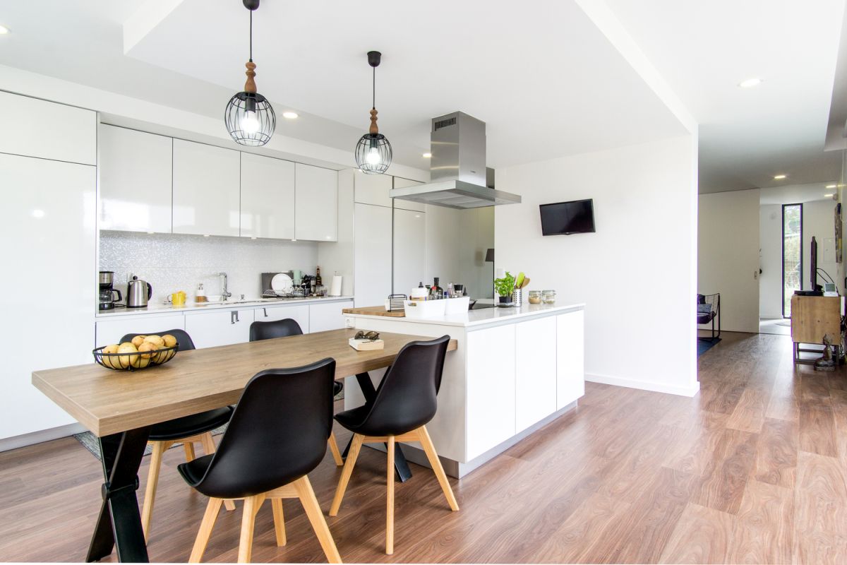 The fireplace wall doubles as a space divider, separating the living room from the kitchen area