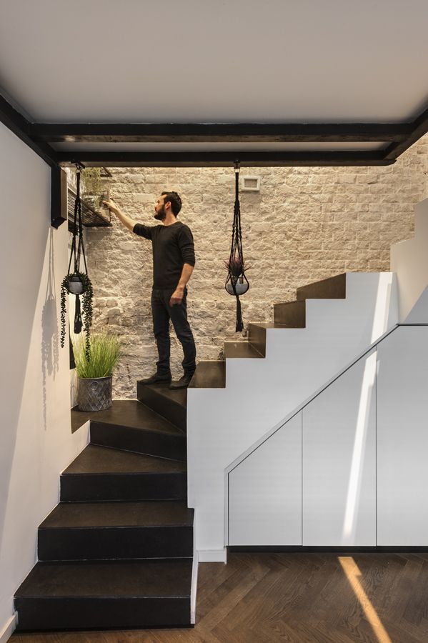 The staircase is framed by a beautiful textured wall on one side, a very cool design details