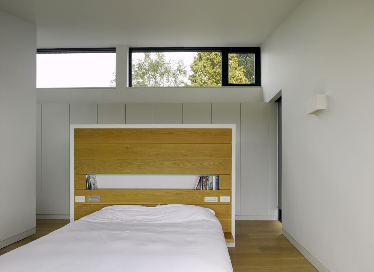 Clerestory windows bring natural light into this bedroom in a subtle but efficient way