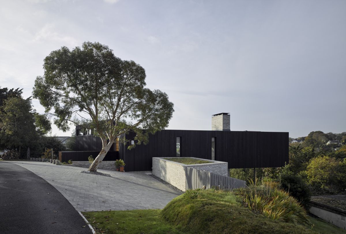 On the outside, the house is clad in dark timber which helps it blend into the landscape