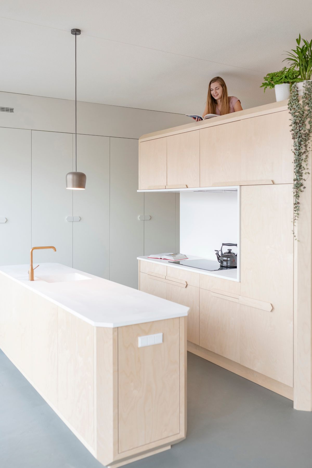 The combination of birch wood and white Corian gives the apartment a modern and clean aesthetic