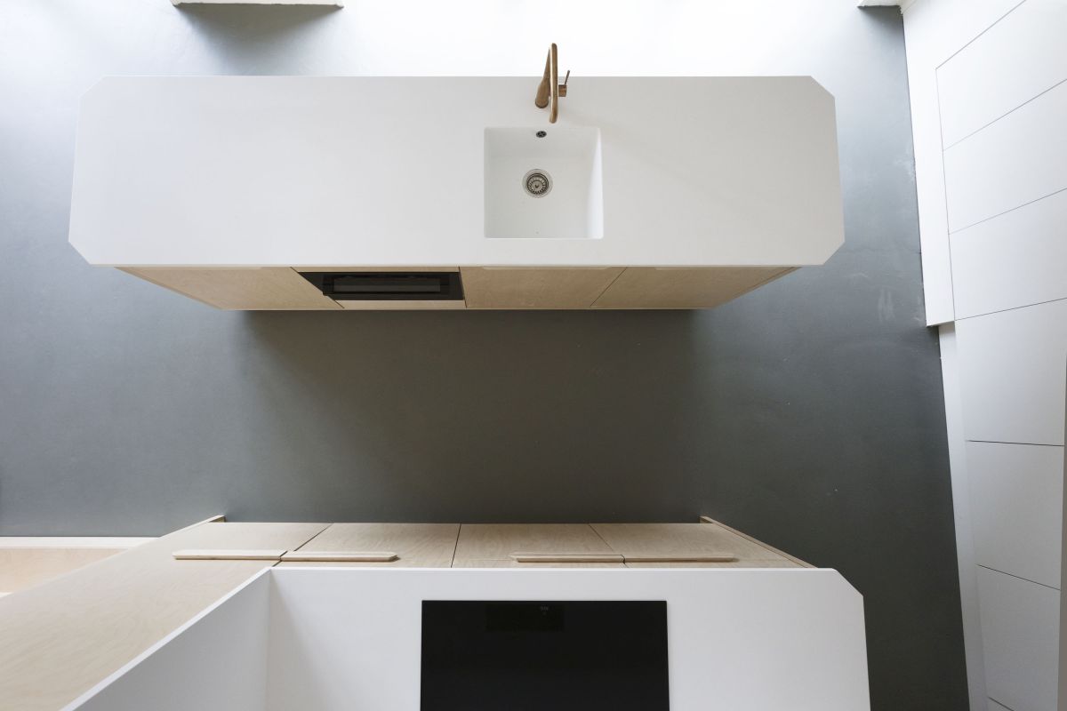 The gray floor and white counters complement the light wood furniture is a very harmonious way