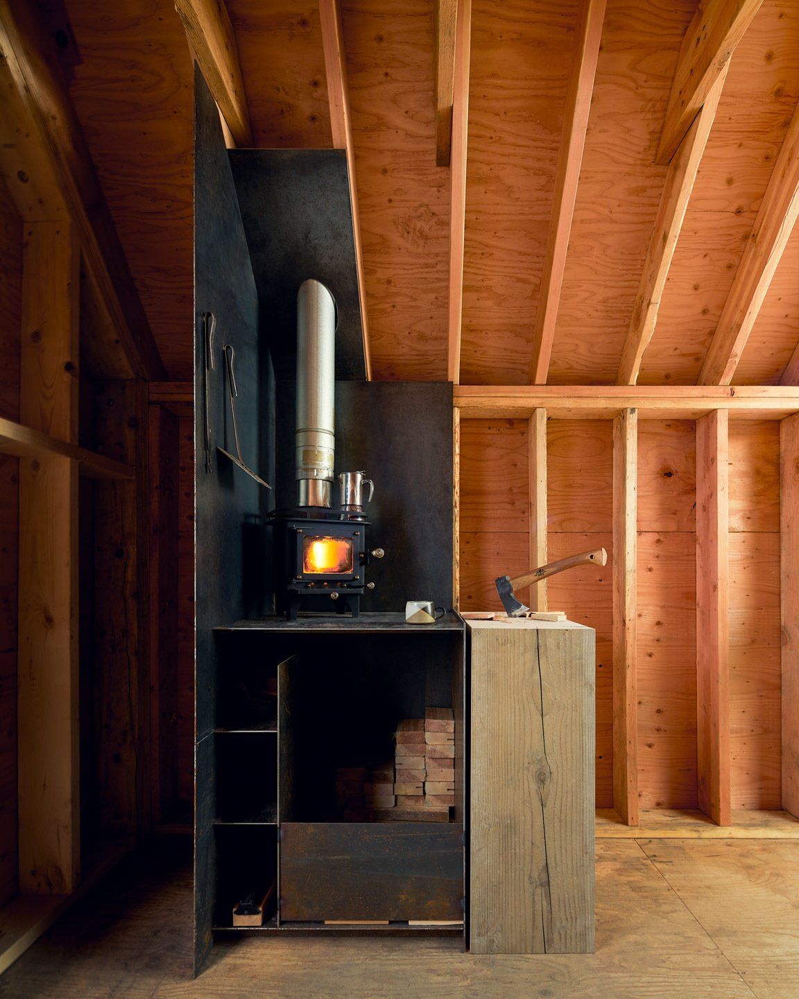 Inside, the cabin looks very cozy, especially with this wood-burning stove in the corner