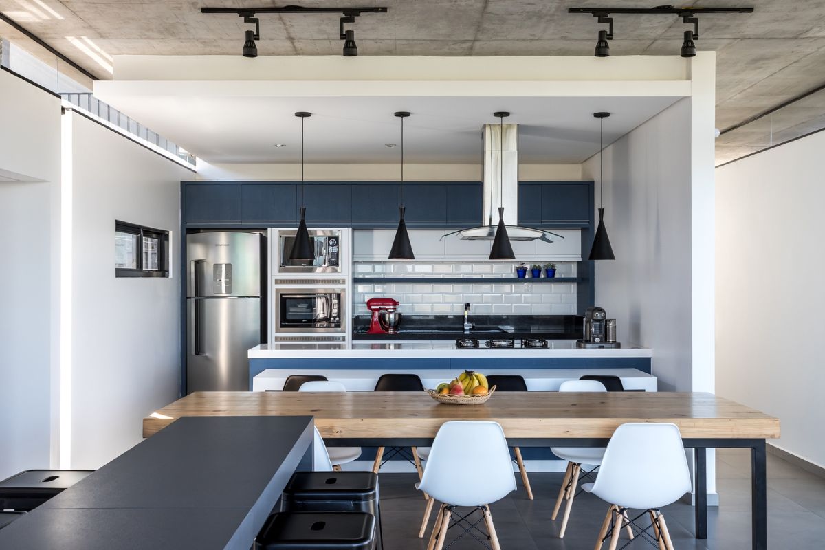 The kitchen is framed by white walls which make it look like its own separate nook