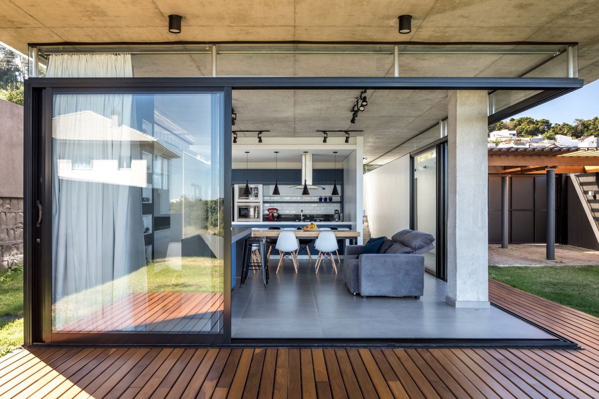 The ground floor has an open floor plan which extends onto a wooden deck that wraps around it