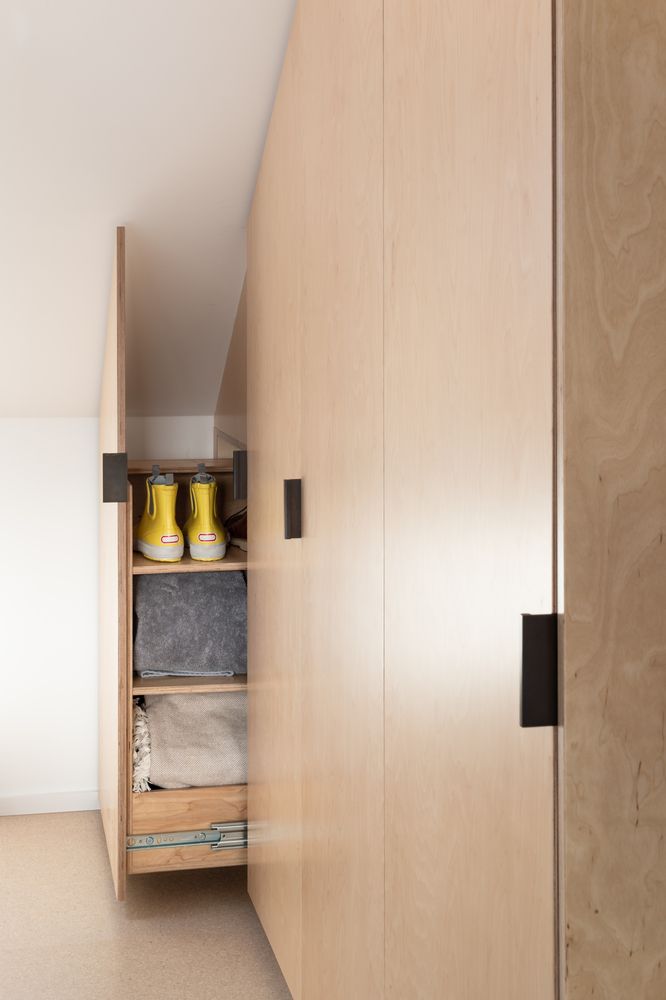 A variety of clever storage solutions were employed throughout the home, including these hidden shelves