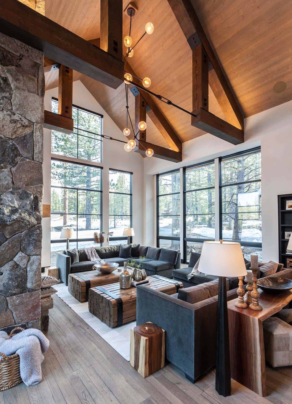 The seating area has comfortable, gray sofas, two wooden coffee tables and stylish lighting fixtures