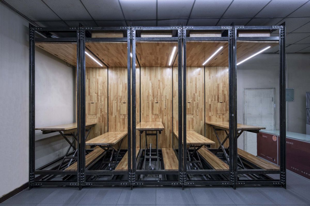 When the desks are completely lowered they become the new office's wooden floor