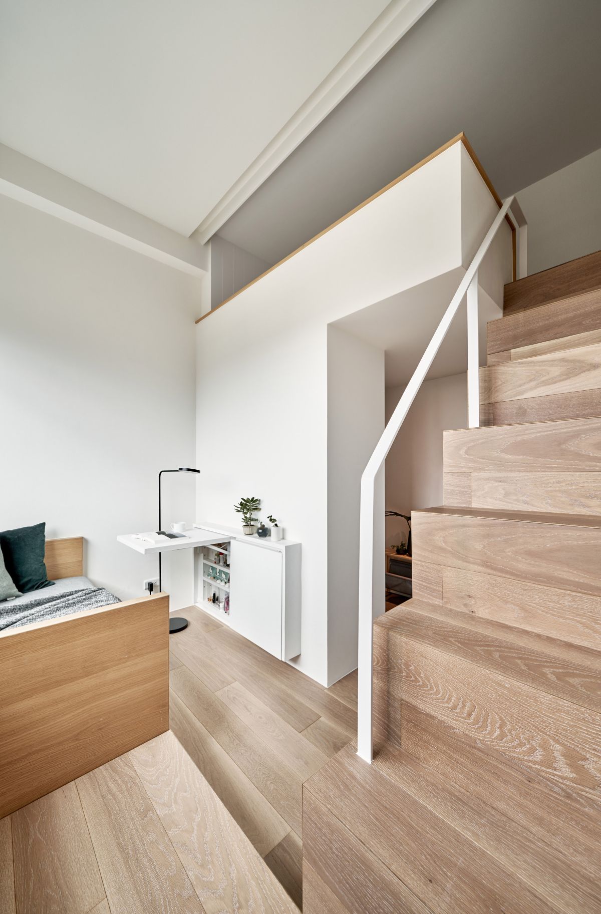 The living room is also the dressing and includes a built-in shoe cabinet and a fold-down desk