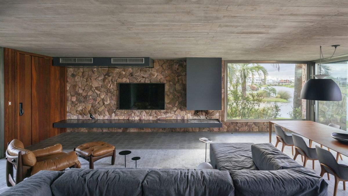 The interior design is defined by a palette of natural materials and finishes, including stone and wood