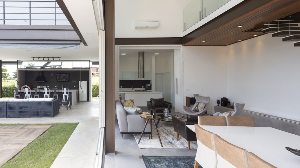 The living spaces are seamlessly connected to the outdoors through sliding glass doors and transitional areas