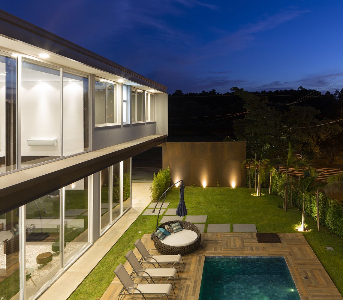 The backyard has a swimming pool which is elegantly framed by a wooden deck
