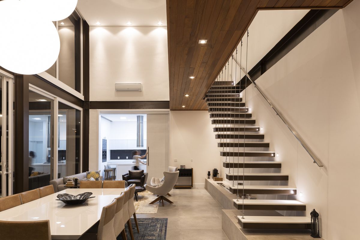 A floating staircase with cord railing connects the two floors without blocking the views