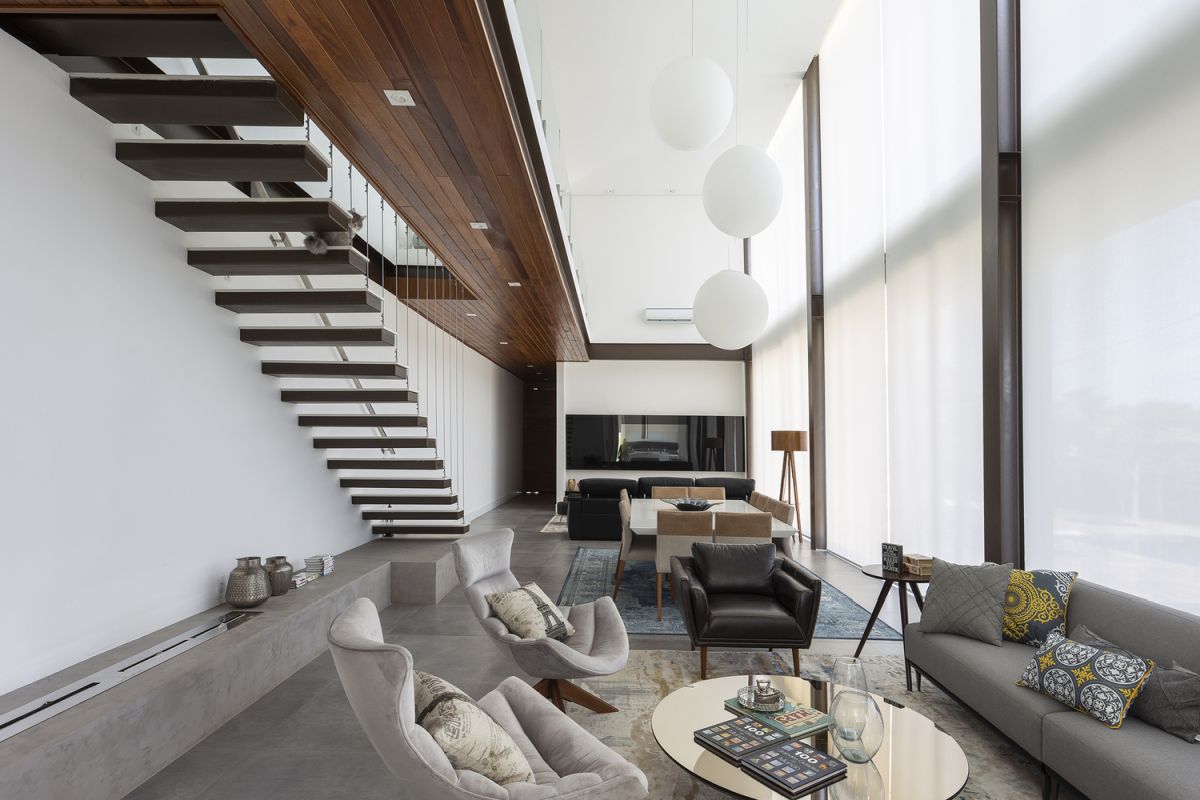 Underneath the staircase there's a concrete module with a built-in contemporary fireplace
