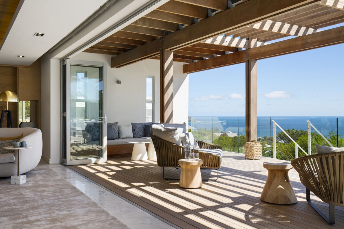 Glass doors seamlessly link the living spaces to the exterior terraces and the panoramic views