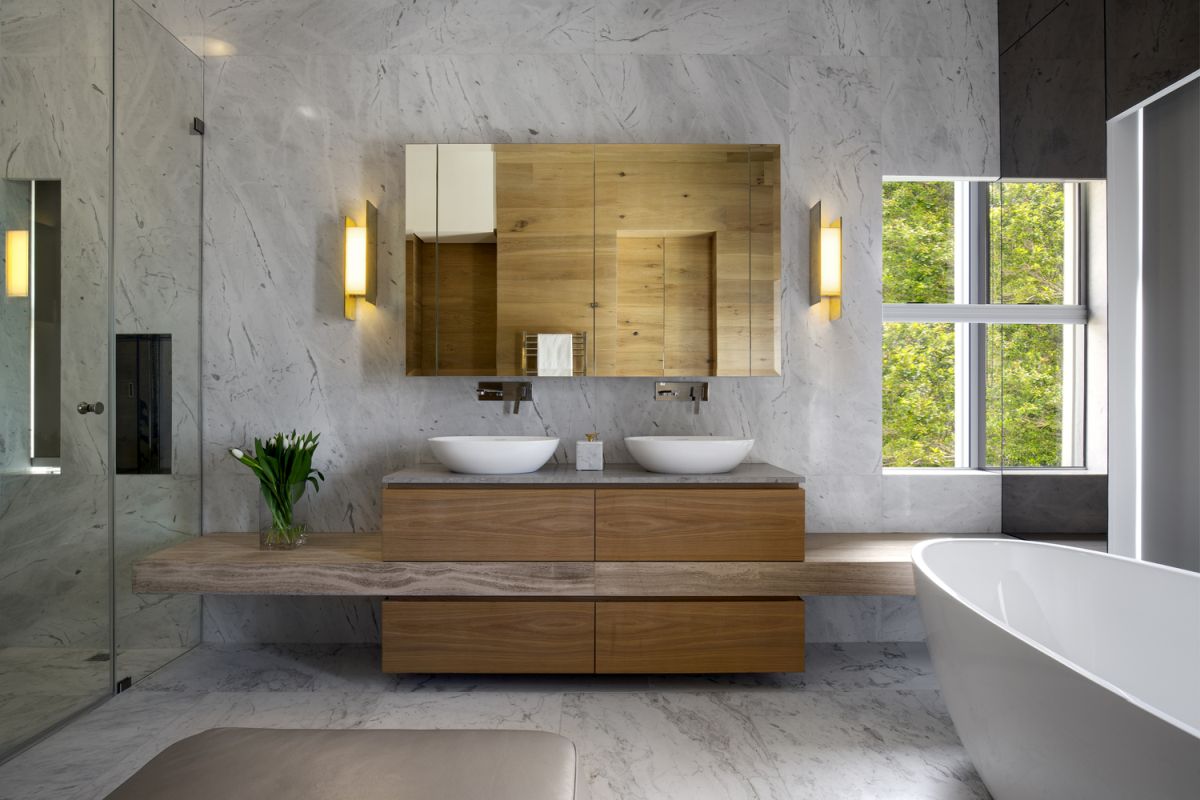 White marble was also used extensively in the bathrooms, where it complements the minimalist fixtures
