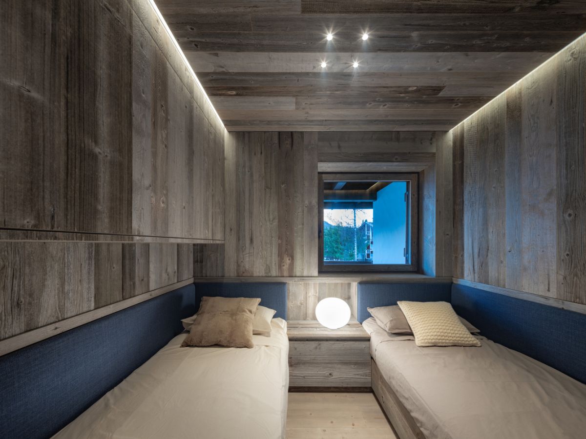 Although small, this double bedroom has a super cozy look which is emphasized by a small, square window