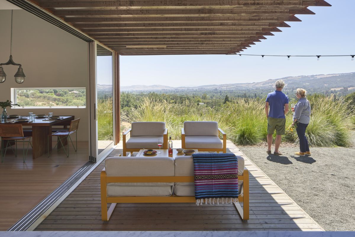 The shaded deck blurs the physical boundaries between the indoor and the outdoor spaces