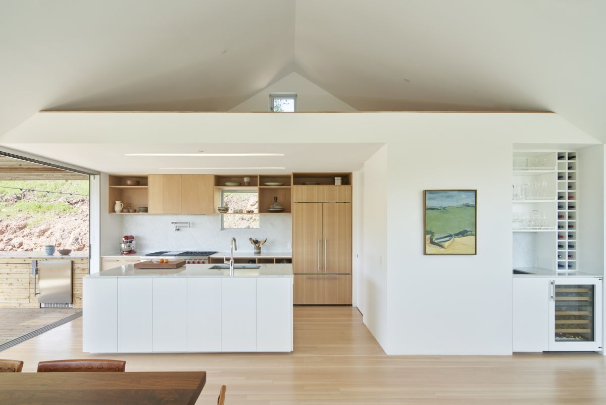 On the inside, the house is simple and bright, with white walls and ceilings and light wooden floors