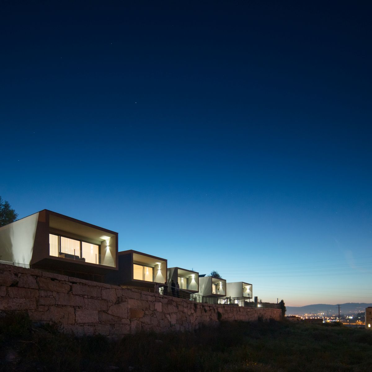 The development is framed by a stone wall which stretches all around it