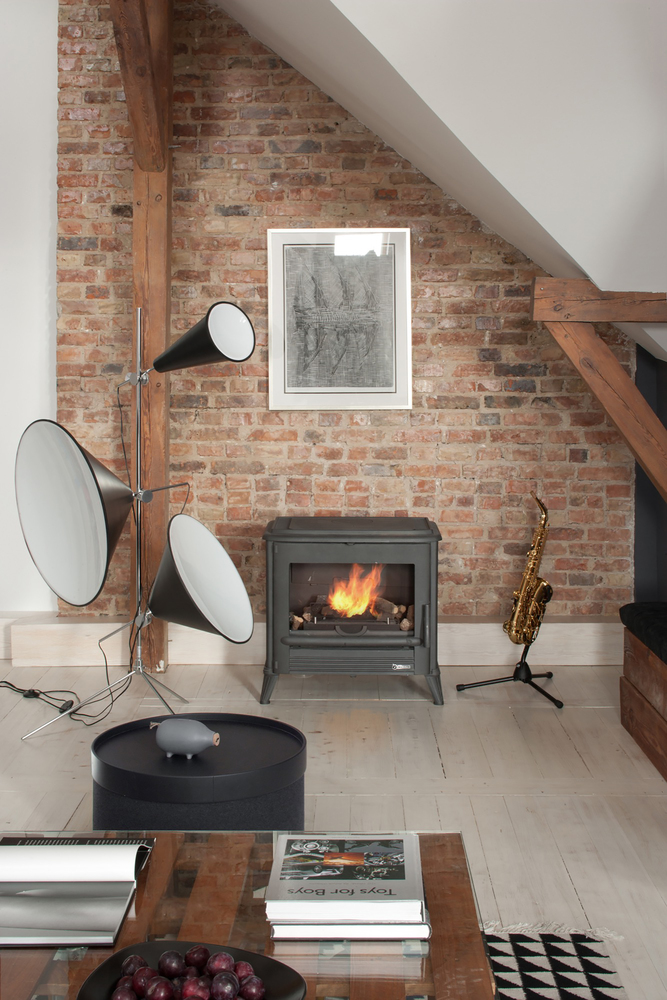 A wood-burning stove in the living room amplify the warm rustic aesthetic of the space