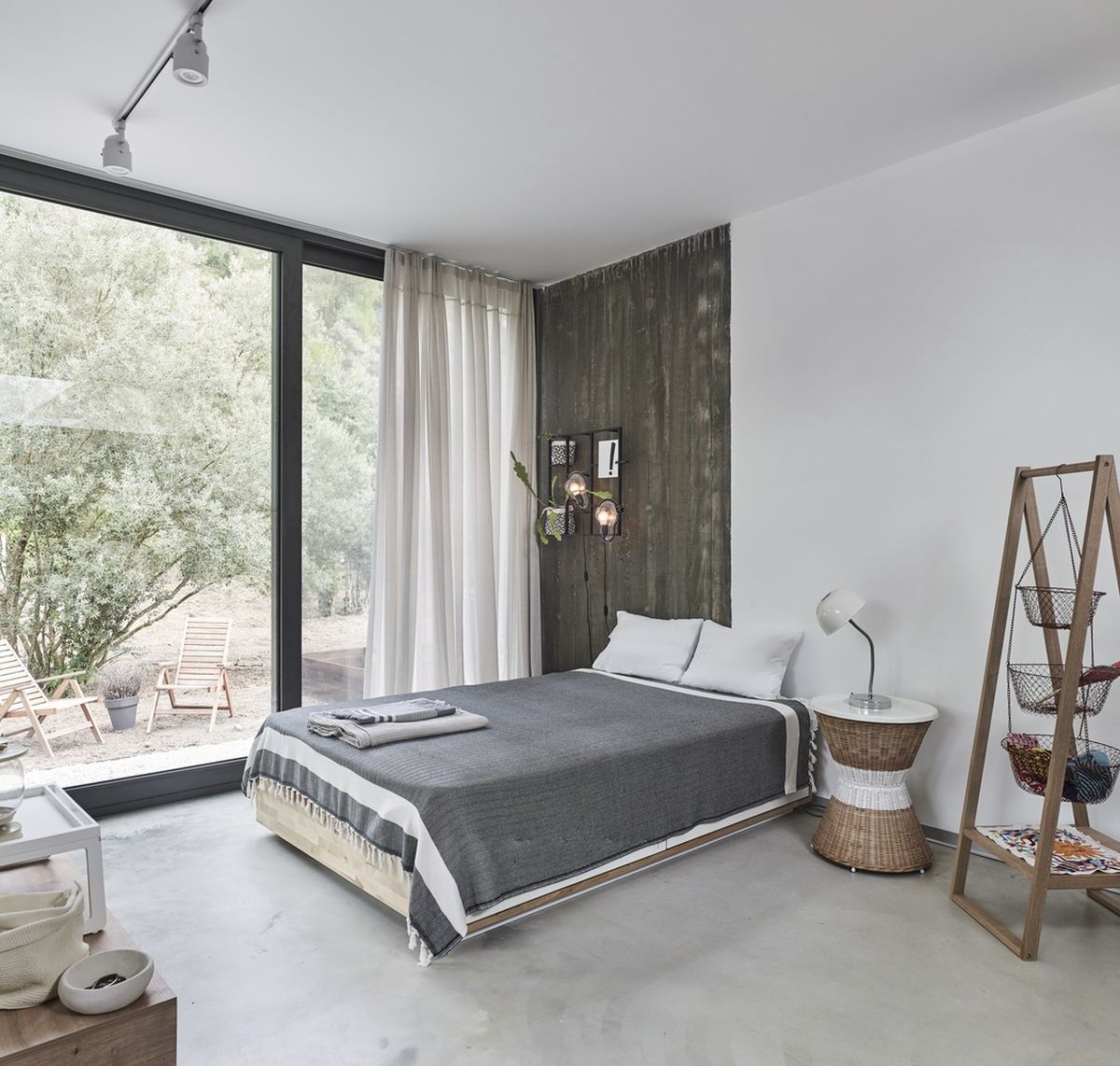 The polished concrete flooring and white walls are complemented by warm wood surfaces