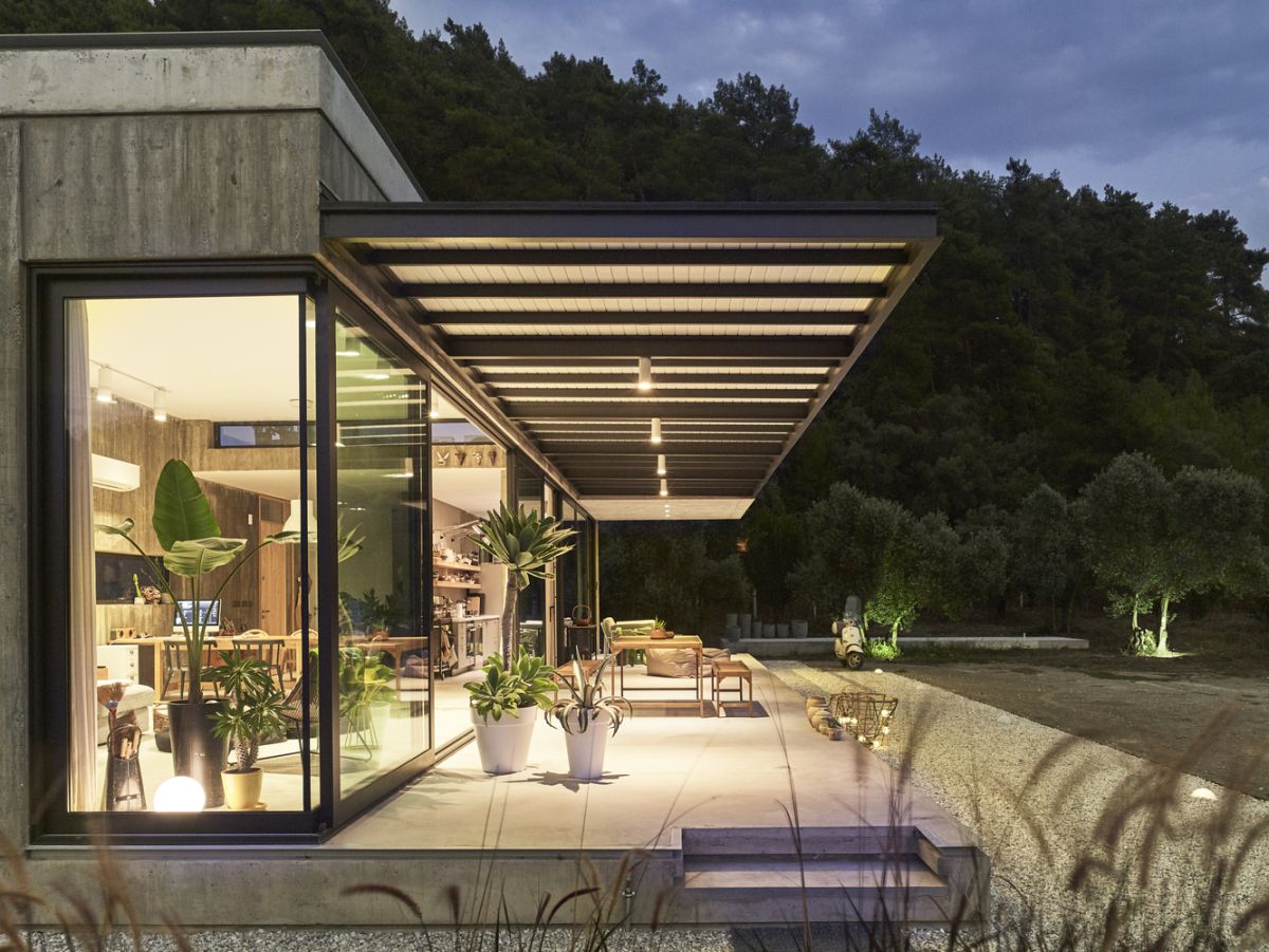 The living areas extend outside onto a sleek deck with majestic views