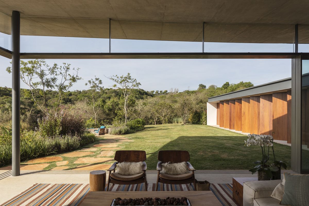 The pivoting wooden panels act as shutters, giving the bedrooms privacy and blocking the sun