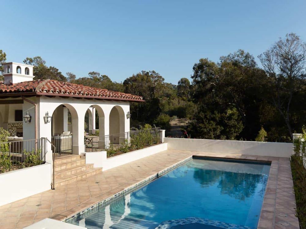 The living areas open onto the backyard which has a large swimming pool