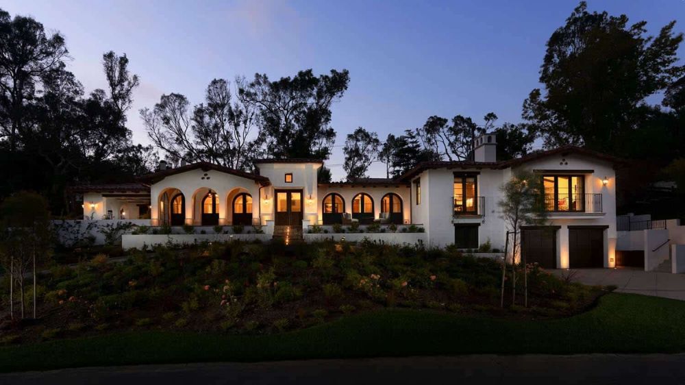 The house looks beautiful and charming inside and out, with arched windows that frame the views